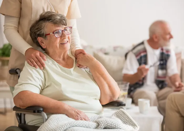 Nurse pushing lady in wheelchair