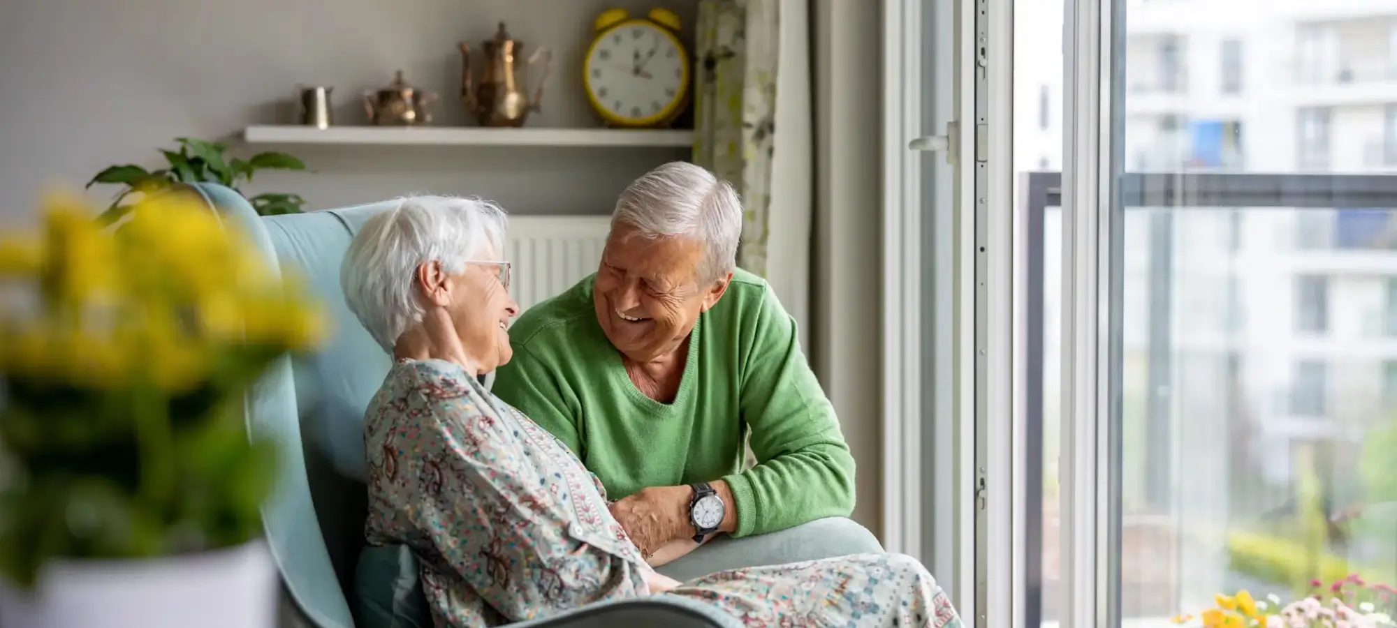 Older couple laughing sitting together