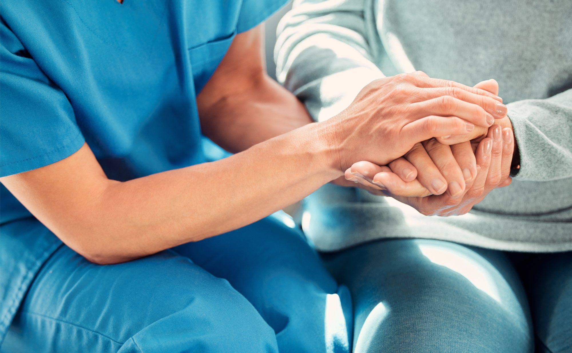 Nurse holding patients hand