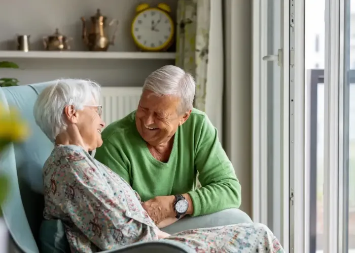 Older couple laughing sitting together