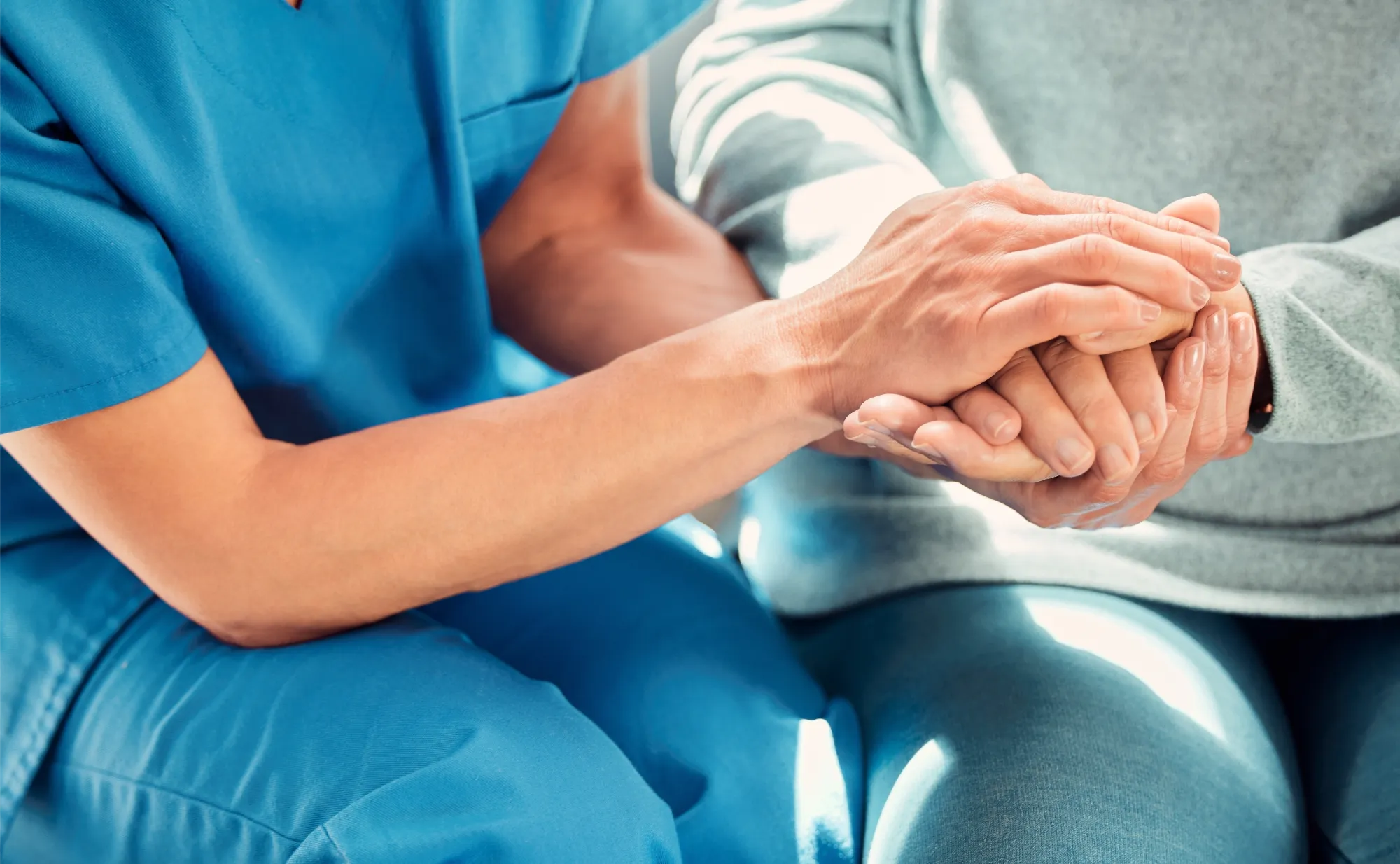 Nurse holding patients hand